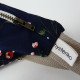 Sac banane Fanny Roseraie Marine à motif floral upcyclé détail zip étiquette